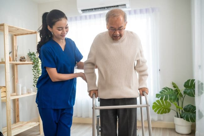 Physical therapist assisting senior patient