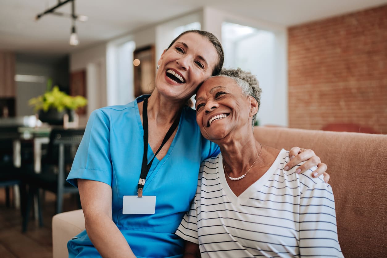 Nurse providing compassionate care to senior patient at home