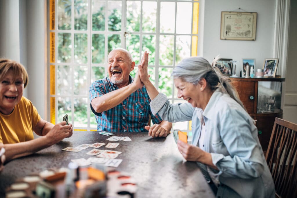 Happy senior citizen with caregiver at home