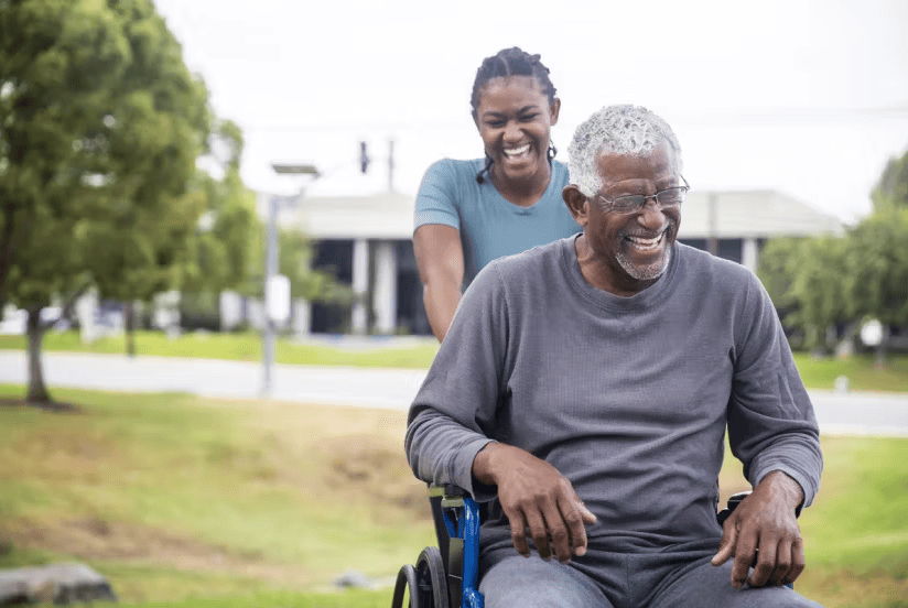 Home health aide assisting elderly patient